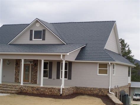 brick house with gray metal roof|matching brick and roof colors.